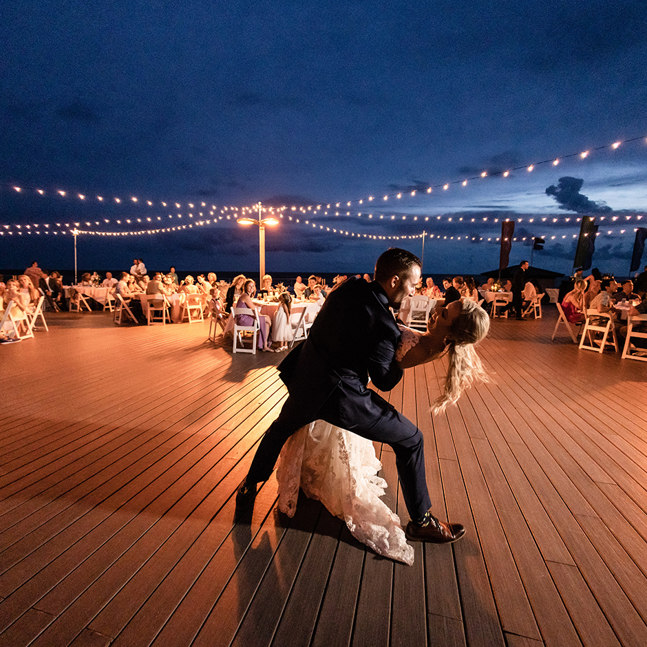 /A groom dancing with his bride at their Destin, Florida wedding venue.