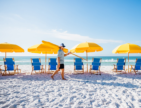 /setting up umbrellas on beach