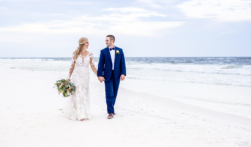 /Bride and groom on beach