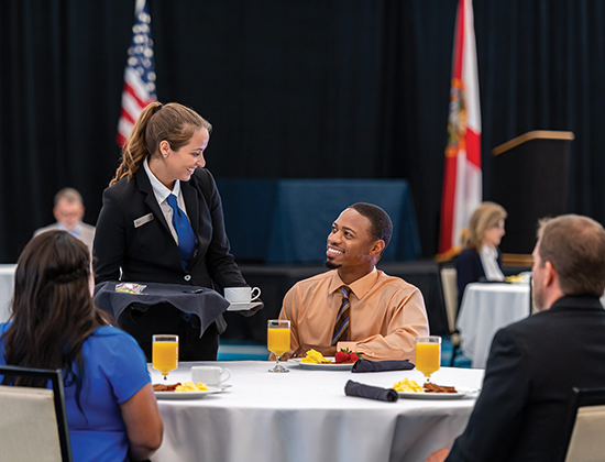 /Waitress serving guest at event