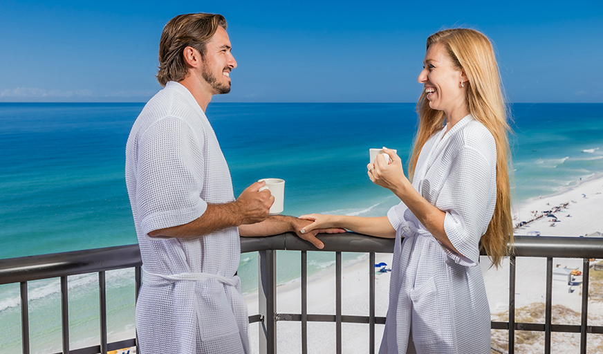 Couple enjoying coffee on a Destin, Florida hotel balcony